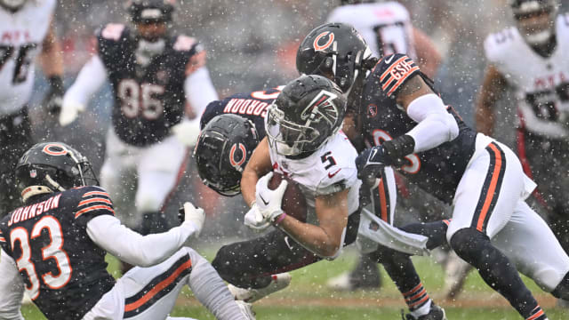 Dec 31, 2023; Chicago, Illinois, USA; Atlanta Falcons wide receiver Drake London (5) is tackled by Chicago Bears defensive back Jaylon Johnson (33), defensive back Kyler Gordon (6) and linebacker Tremaine Edmunds (49) after a short pass gain in the first half at Soldier Field.